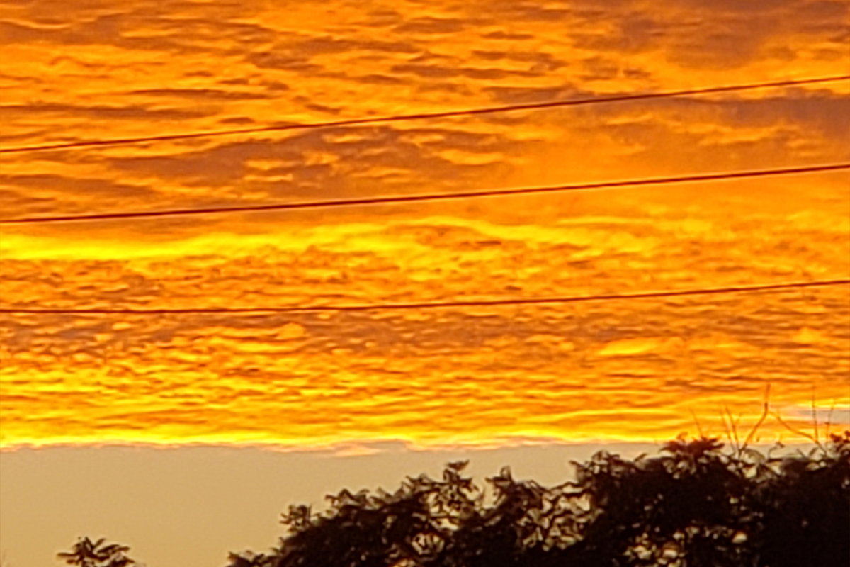 Clouds bathed in bright orange and yellow light